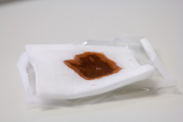 a doctor dribbles antibacterial fluid on a compress