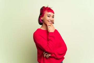 Young woman with red sweater smiling and looking to the front with confident face