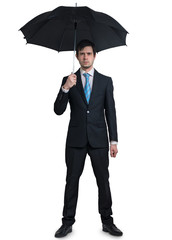 Young businessman in suit with umbrella isolated on white background.