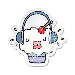 distressed sticker of a cartoon cupcake listening to music