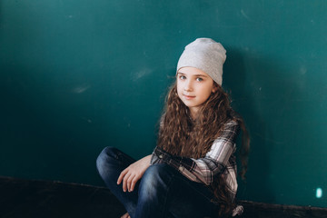 Teen pretty cute caucasian girl posing at home on green wall background. Beauty, childhood, emotions concept