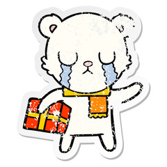 distressed sticker of a crying polar bear cartoon with christmas gift