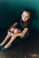 Fototapeta premium Teen pretty cute caucasian girl posing at home on green wall background. Beauty, childhood, emotions concept