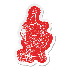 cartoon distressed sticker of a dead fox wearing santa hat
