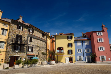 Fototapeta na wymiar Colorful apartments at the Punta point of Piran Slovenia on the Adriatic sea coast near the lighthouse and Church of St Clement