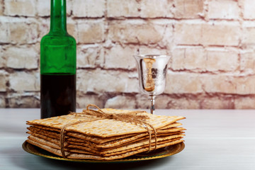 Jewish passover matzah on decorated silver wine cup with matzah, jewish symbols for pesach holiday.