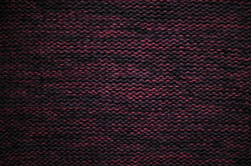 Knitted background. Burgundy wool knit fabric texture. 