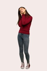 A full-length shot of a Teenager girl with turtleneck making sleep gesture in dorable expression over isolated background