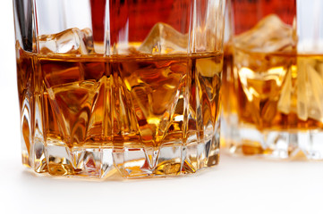 Glasses of scottish whiskey with ice cubes