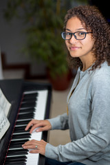 Woman playing the piano inside