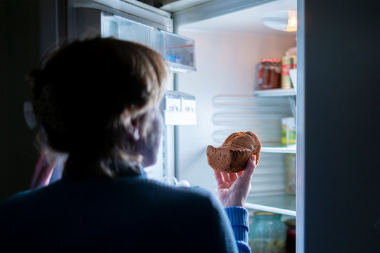 Woman Eating Cake In The Night From The Fridge