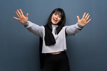 Young sport woman counting ten with fingers