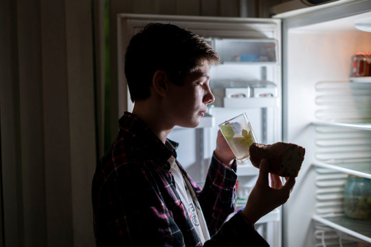 Teenager Eat Junk Food Near Fridge At Night