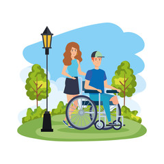 young man in wheelchair with female helper