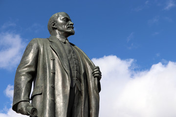 Monument to Lenin, the leader of the russian proletariat against blue sky with white clouds