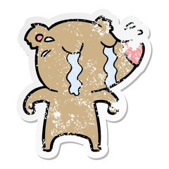 distressed sticker of a cartoon crying bear