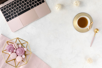 View from above of woman business workplace with computer keyboard, notebook, pink peony flower bouquet and mobile phone, flat lay.