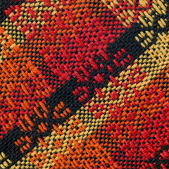 Handwoven patterned fabric in black, yellow, orange and red