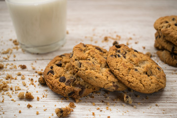 chocolate chip cookies with crumbs on a wooden table