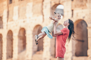 Young mother and little girl exploring Coliseum outside in Rome, Italy.