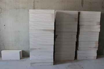 the texture of the foam blocks for construction of walls, concrete blocks are stacked in piles. preparation for work, purchase of building materials. accuracy in the work of the team. 
