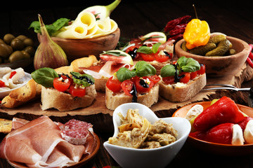Italian antipasti wine snacks set. Cheese variety, Mediterranean olives, pickles, Prosciutto di...