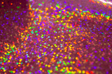 Multicolored shiny glamorous circles on an uneven surface.