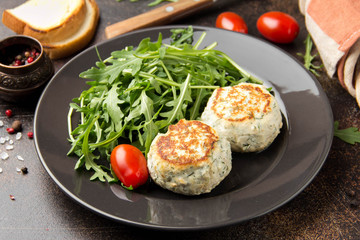 Fried chicken cutlet with herbs, delicious healthy lunch, children's food, diet. Meatballs with salad on dark background