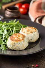 Fried chicken cutlet with herbs, delicious healthy lunch, children's food, diet. Meatballs with salad on dark background
