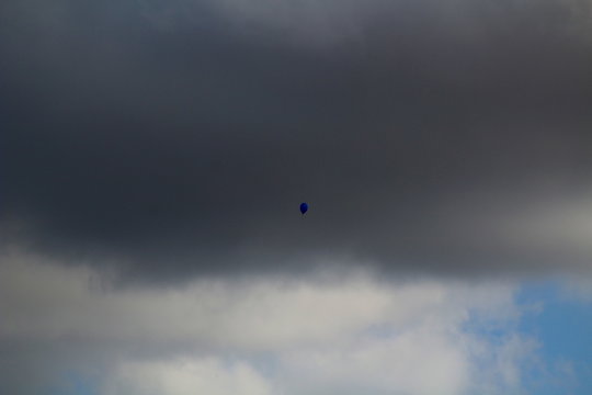 Blue balloon alone in sky