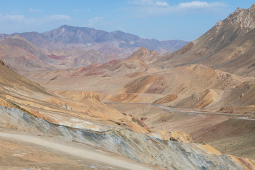 Desert landscape in the area of Ak-Baital Pass with road in the Pamir Mountains in Tajikistan