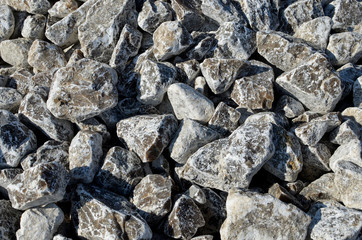 Natural gypsum stone. Close up image of stones with black and white. Industrial mining area. Limestone mining, quarry. Wall texture, stone background, round stones