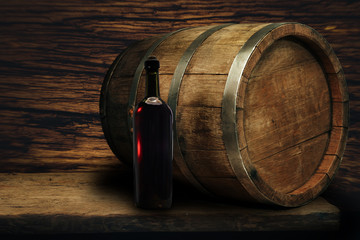 Red wine bottle on a old oak wooden table background barrel.