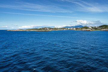 Fototapeta na wymiar Beautiful sunny landscape of Western Norway coastline near Kristiansund viewed from cruise ship