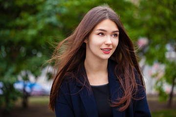 Fototapeta premium Young beautiful brunette girl in the autumn park