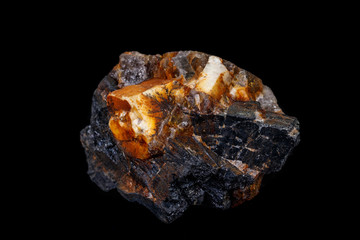 Macro of the mineral stone Columbite, Beryl, Feldspar on a black background