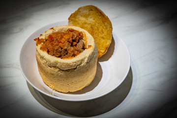 Close up photo of traditional Romanian goulash served in bread