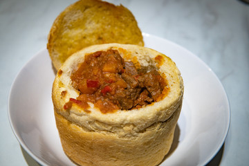 Close up photo of traditional Romanian goulash served in bread
