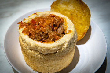 Close up photo of traditional Romanian goulash served in bread