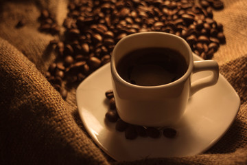 Fragrant roasted coffee in a white cup.