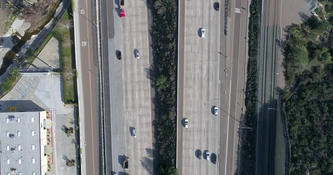 A slowed down overhead view of traffic on the highway in sunny California.