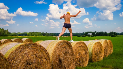 Naklejka na ściany i meble Bales of hay in Agricultural fields