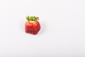 Ugly organic strawberries isolated on white background