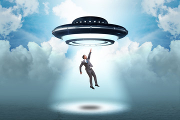 Flying saucer abducting young businessman 