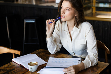 Confident businesswoman working with documents