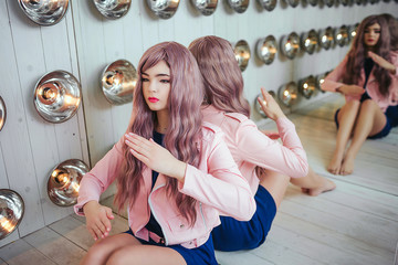 Fashion freak. Portrait of glamour synthetic girl, fake doll with empty look and long lilac hair is...