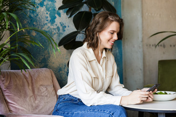 Smiling businesswoman having lucnch at the cafe