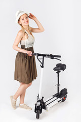 Full length portrait of a woman with white scooter isolated on white background