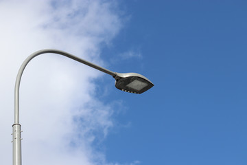 LED street lamp isolated on blue sky background. Led lights saving electrical energy