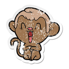distressed sticker of a cartoon laughing monkey